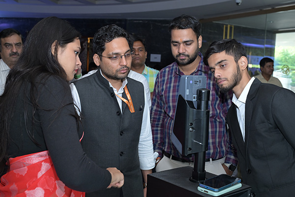 Visitors inspecting heavy mining machinery on the exhibition floor