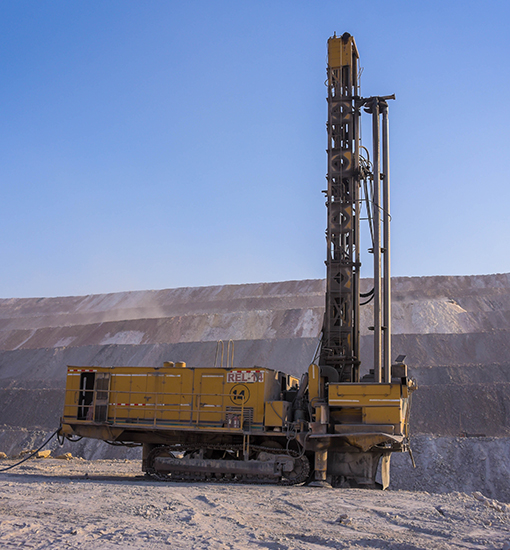 Field geologist operating survey equipment on site